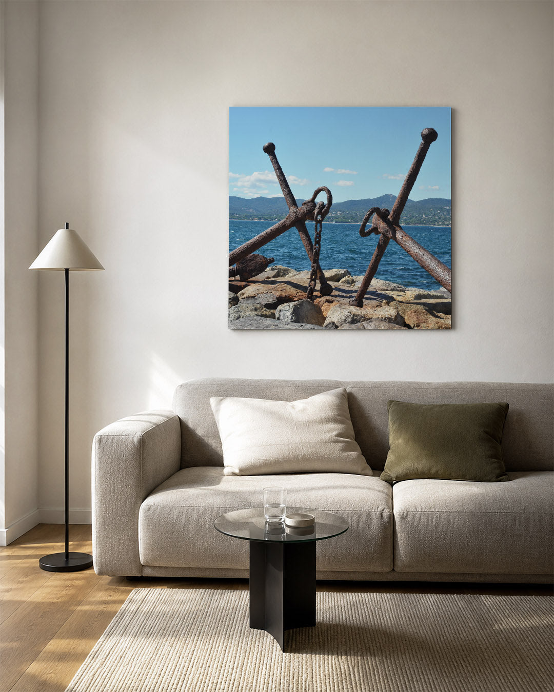 Ankers aan zee kunstwerk – vierkante wanddecoratie – twee verweerde ankers rusten op rotsen aan de kust, met een blauwe zee