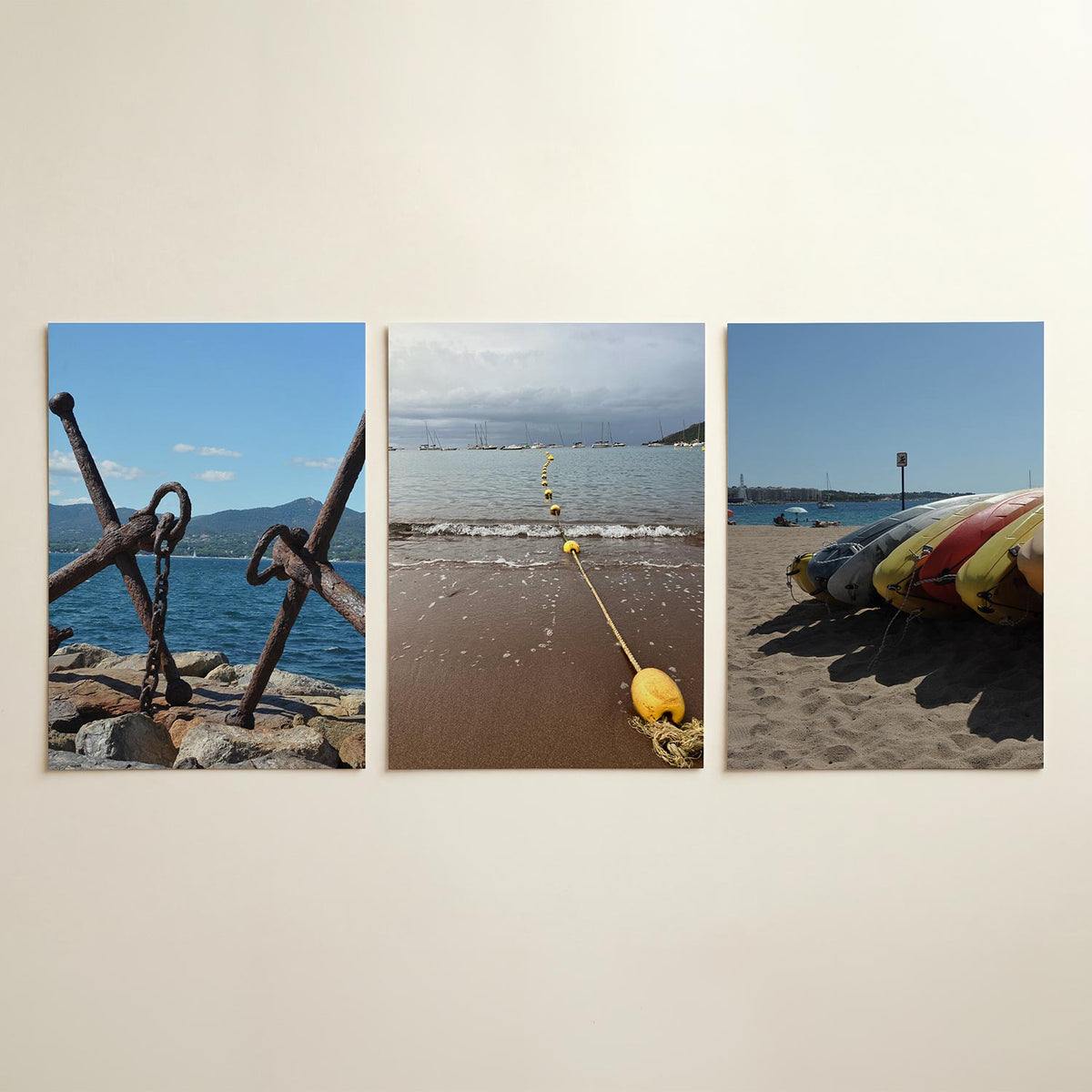Anker en zee posterset – detailweergave – roestige ankers rusten op rotsen met een blauwe zee en groene heuvels op de
